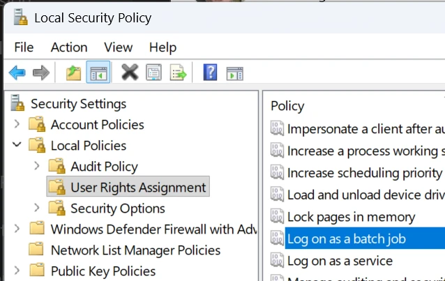 Local Security Policy editor showing the "Log on as a batch job" setting under "Security Settings -> Local Policies -> User Rights Assignment"